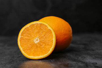 Fresh ripe oranges on black background