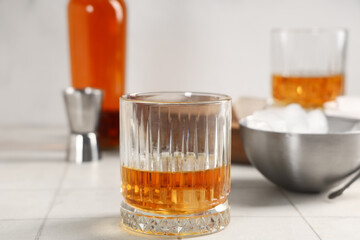 Glass of cold rum on blurred background. Closeup