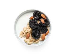 Bowl of tasty oatmeal with prunes, almonds and milk on white background