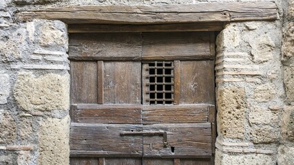 Old front door with iron grille, Civita di Bagnoregio, Lazio, Italy, Europe
