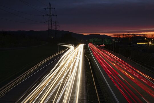 Long exposure of an illuminated motorway at night with disappearing light traces of vehicles, Kaiseraugst, Canton Aarau, Switzerland, Europe