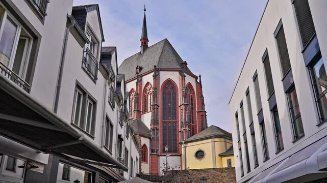 Liebfrauenkirche, or Church of Our Lady, Catholic church down a city street with tracking movement on a sunny day, Koblenz, Germany