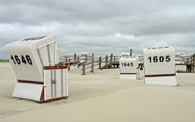 White beach chairs at the empty beach of Sankt Peter Ording, Schleswig-Holstein, Germany, Europe