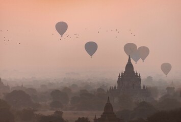 View of pagodas with hot air balloons, temples, sunrise, haze, morning light, Bagan, Division...