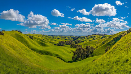 Obraz premium Green mountain scene in spring with clear blue sky and clouds.