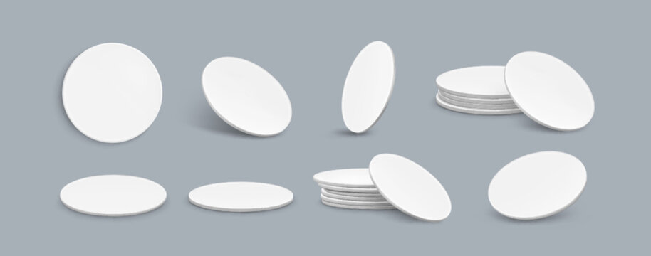 Drink coaster mockup set of blank round white objects from different angles - single piece, stacked pile, tilted position on gray backdrop. Clean minimalist template for branding presentation.
