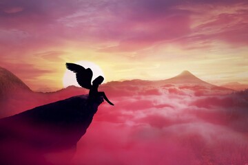 Silhouette of a lonely fallen angel with long wings standing on a cliff against a paradise sunset. Dusk sky over the clouds in the mountains. Heaven landscape scene screen saver © PsychoShadow/imageBROKER