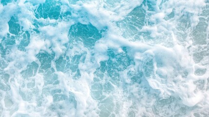 Obraz premium Turquoise ocean waves crashing gently against the shore under a bright blue sky