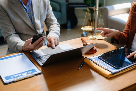 Two lawyers are discussing about contract paper, law matters determination, pointing.law