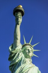 Fototapeta premium Statue of Liberty in front of blue sky, Liberty Island, Statue of Liberty National Monument, New York City, New York, USA, North America