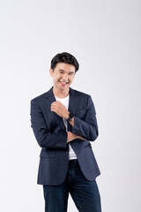 A man in a blue suit and white shirt poses for a photo