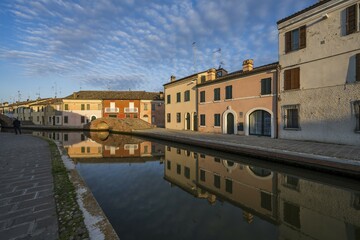Houses reflected in the canal, Via Agatopisto, Comacchio, Emilia Romagna, Italy, Europe