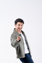 A man in a green jacket is smiling and waving