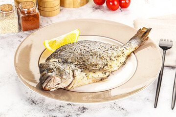Baked Dorado fish served lemon