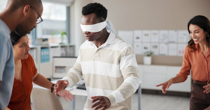 Blindfold, coordination and team building with business people in office for communication skills development. Directions, instructions or trust with employee group in creative workplace for bonding