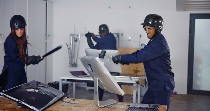 Vandalism, weapon and people in rage room for anger management, cathartic therapy and energy. Bat, safety gear and golf club with friends in smash center with emotion, break and stress relief