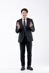 Obraz premium A man in a black suit and tie stands in front of a white background