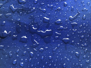 Water drops on blue metallic surface