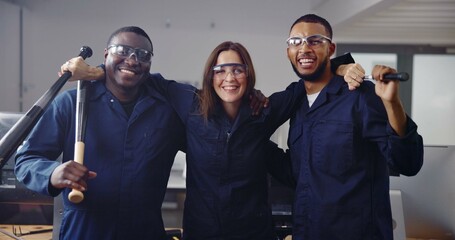 Portrait, weapon and friends in rage room for satisfaction, anger management and stress relief. Bat, safety gear and unwind with people in smash center for demolition success and cathartic therapy