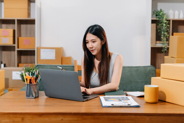 Woman start up small business owner at workplace. small business entrepreneur SME or freelance asian woman working with box at home