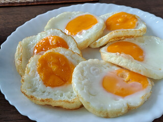 Fried eggs are made by cracking eggs and frying them in oil. Fried eggs are a popular food eaten for breakfast in many countries.