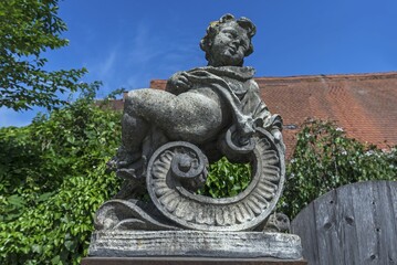 Baroque putto figure on a pedestal, Nördlingen, Bavaria, Germany, Europe