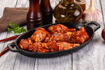 Raw marinated buffalo chicken wings