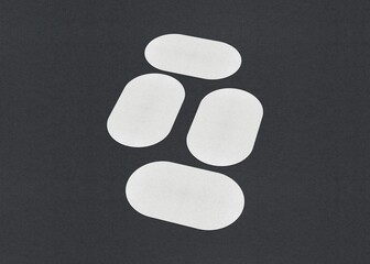 Four white rounded rectangles arranged on a dark background in a geometric pattern, Blank white Business card mockup stacks at grey textured paper background