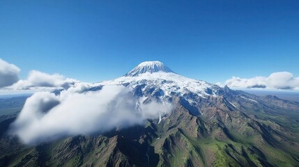 Snow Capped Mountain Peak Soaring Above Clouds