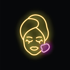 Neon sign of a woman wearing a towel and a cosmetic face mask, applying cream on her cheek