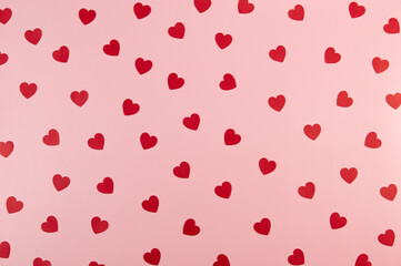 Top view of red hearts on pink background. Valentine's day, red hearts, love wallpaper. Flat lay, copy space.