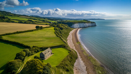 An aerial view of the iconic Oldfield Chapel, surrounded by green meadows along the picturesque coastline and perched atop white cliffs.