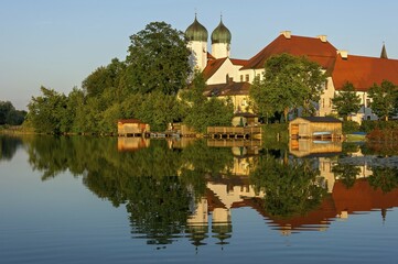Fototapeta premium Benedictine Kloster Seeon monastery with monastery church of St. Lambert, Klostersee, Seebruck, Chiemgau, Upper Bavaria, Bavaria, Germany, Europe