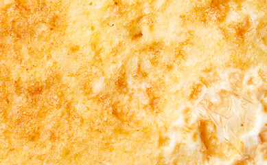 A close up of a yellow and brown dish with a lot of texture