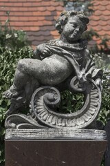 Fototapeta premium Putti figure on a wall, Nördlingen, Bavaria, Germany, Europe