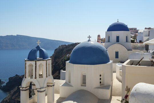 Blue-domed church of Agios Spiridonas and the church of Anastasis, Oia, Santorini, Greece, Europe