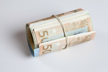 Roll of money with rubber band, multiple bank notes, Euros