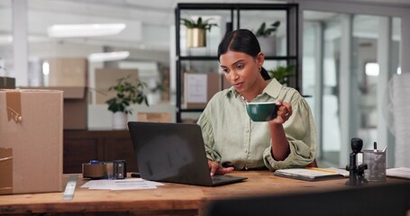 Boxes, business and woman with laptop, coffee and typing with ecommerce, sales report and website info. Seller, person or entrepreneur in workspace, computer and latte with cappuccino or supply chain