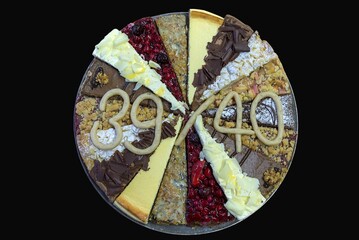 Birthday cake, mixed cake pieces in a cake tin, black background, Germany, Europe