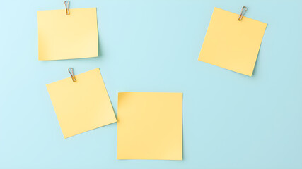 Paper notes with clip on light blue background, top view. Space for text. Generative AI