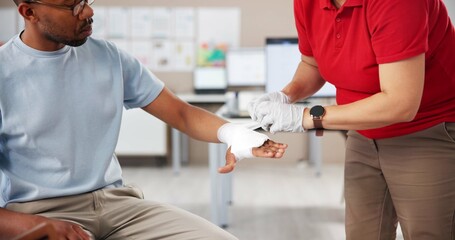 Hands, people and first aid with bandage, teaching or tutorial with care, attention or help at...