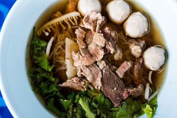 A bowl of noodles with stew beef and entrails. Beef noodle