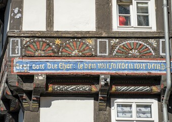Coloured carving on half-timbered house, Butterhanne restaurant, Old Town, Goslar, Harz Mountains, Lower Saxony, Germany, Europe