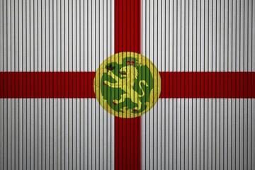 Alderney flag painted on the cracked grunge concrete wall