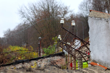 
Barbed wire wall with brick posts.