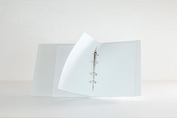 White Folder With Sheets Of Paper Turns Over