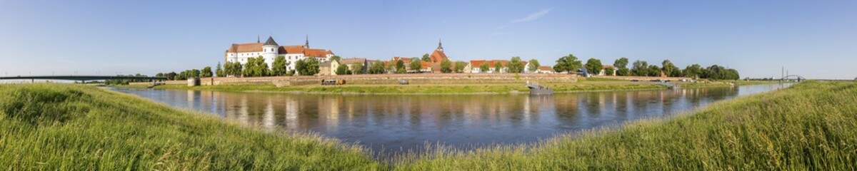 Fototapeta premium Panorama from the Elbe riverbank with new Elbe bridge, castle, municipal church and Elbe in Torgau, district of Northern Saxony, Saxony, Germany, Europe