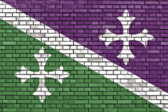 Flag of Adjuntas painted on brick wall