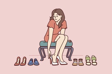 Shopaholic woman is trying on shoes in store choosing right high heels for going to party. Girl visitor of fashion boutique with shoes who loves shopping and wants to change wardrobe