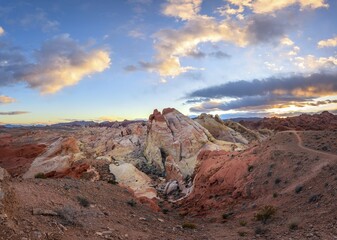 Colorful, red orange rock formations at sunset with colored clouds, White Dome, sandstone rocks, Valley of Fire State Park, Mojave Desert, Nevada, USA, North America